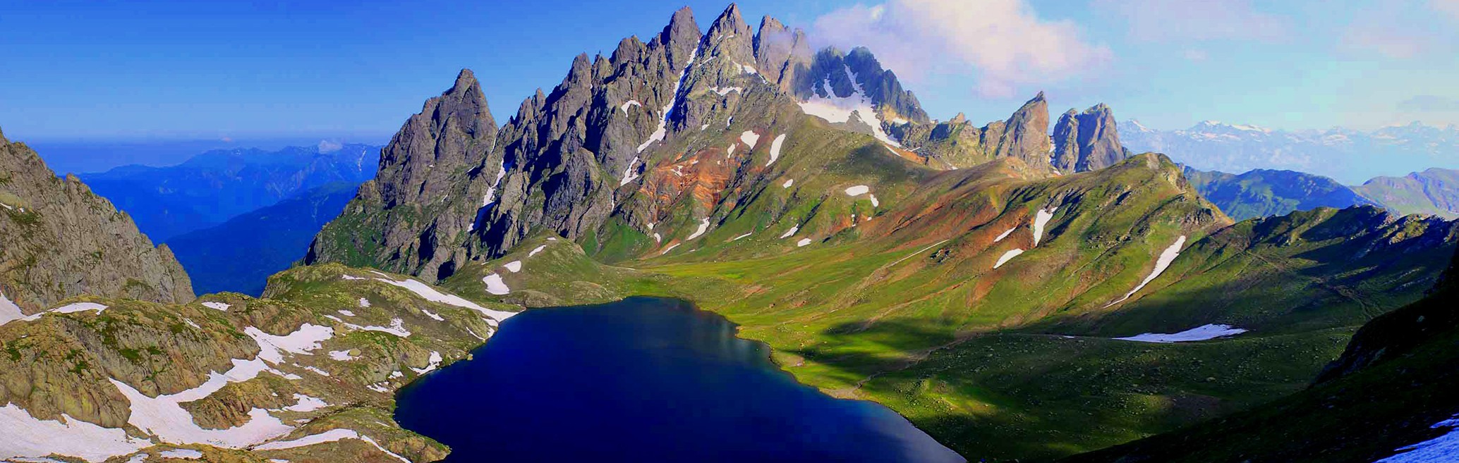 Tobavarchkhili Lake surrounded by Caucasus mountains